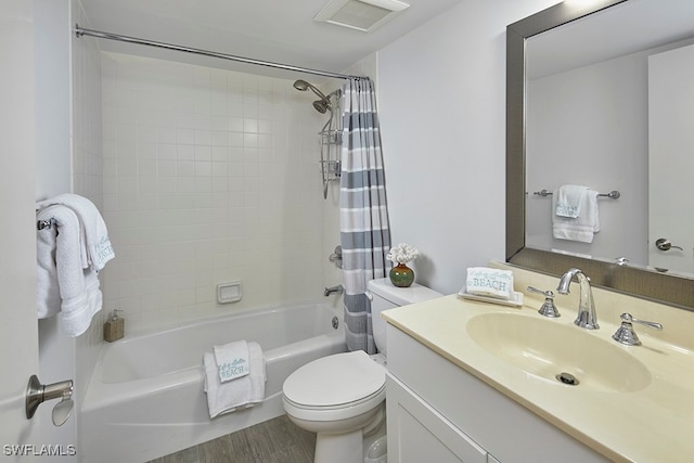 full bathroom featuring shower / bathtub combination with curtain, vanity, hardwood / wood-style floors, and toilet