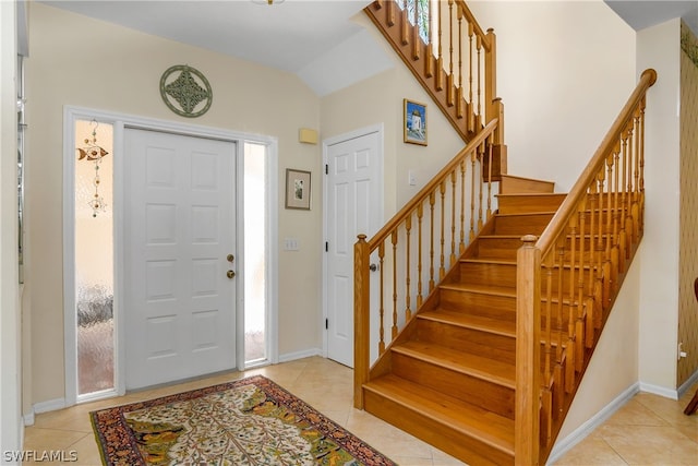 entrance foyer with light tile patterned flooring and lofted ceiling