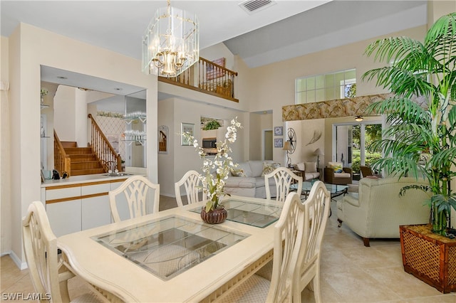 dining area with light tile patterned flooring and an inviting chandelier