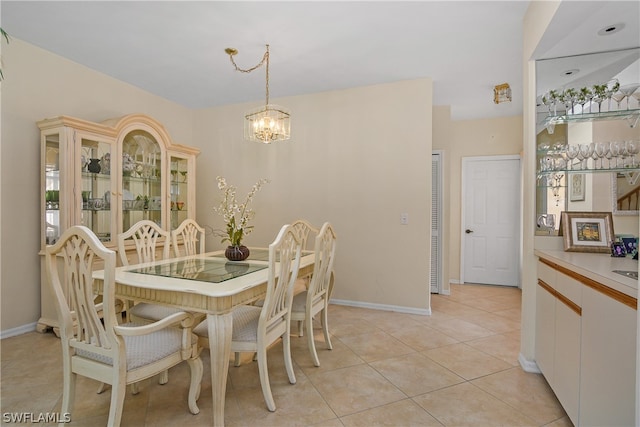 tiled dining space featuring a notable chandelier