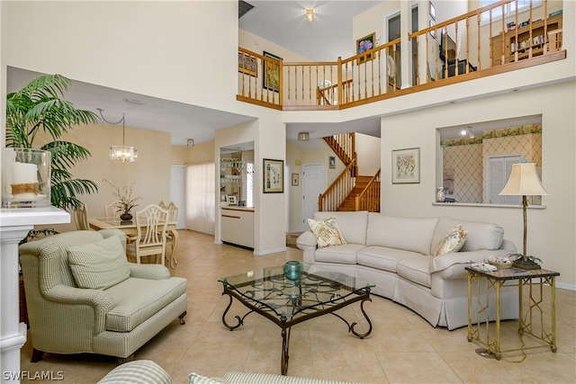 tiled living room featuring a notable chandelier and a high ceiling