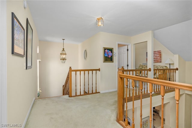 hallway featuring light colored carpet