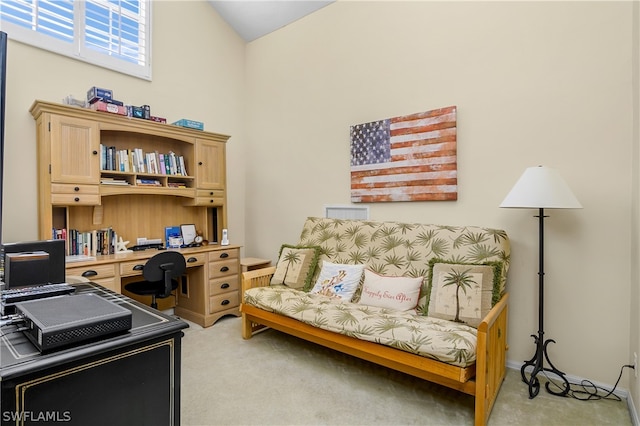 office area with light carpet and high vaulted ceiling