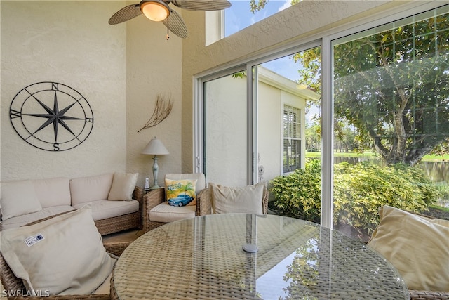 sunroom / solarium featuring ceiling fan