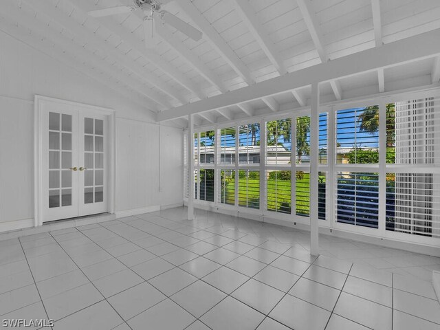 interior space featuring ceiling fan, french doors, and lofted ceiling with beams