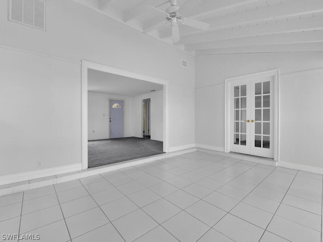 tiled spare room with visible vents, ceiling fan, vaulted ceiling with beams, and french doors