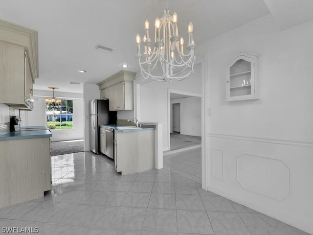 kitchen with visible vents, a notable chandelier, a sink, stainless steel appliances, and light tile patterned flooring