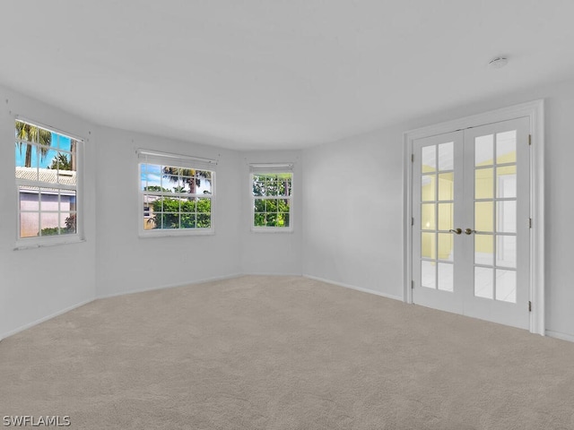 unfurnished room with carpet flooring and french doors