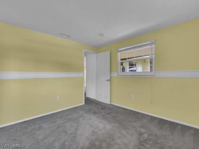 carpeted spare room with baseboards