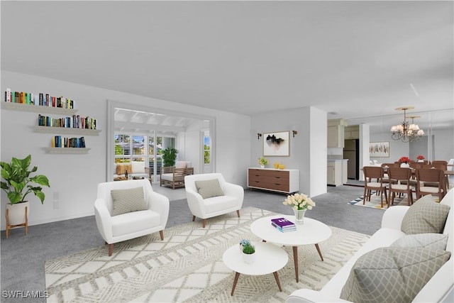 carpeted living room with a notable chandelier