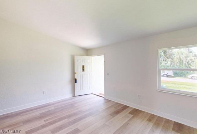 spare room with light hardwood / wood-style floors