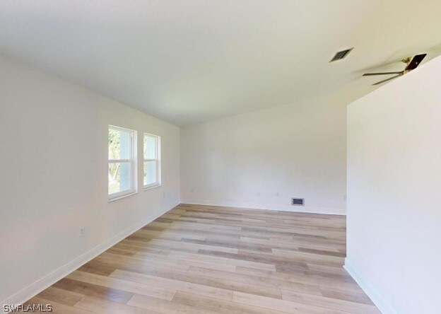 spare room featuring light hardwood / wood-style flooring and ceiling fan