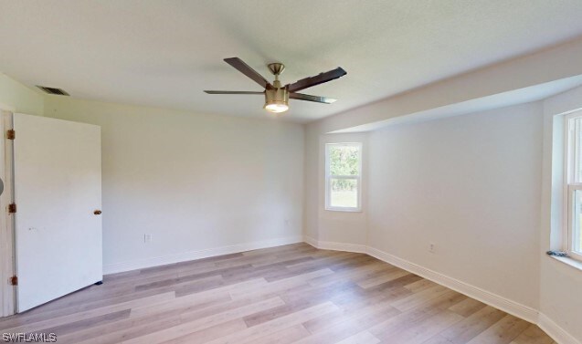 spare room featuring light hardwood / wood-style floors and ceiling fan