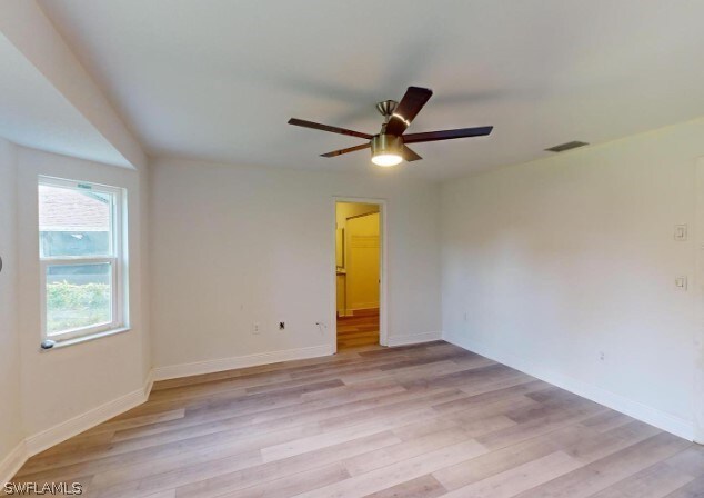 empty room with light hardwood / wood-style floors and ceiling fan