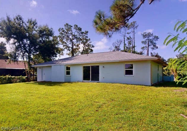 rear view of house with a lawn