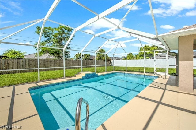 view of swimming pool featuring a lawn, glass enclosure, and a patio