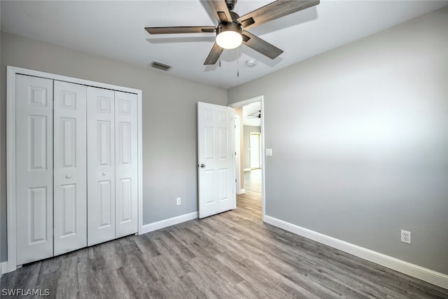 unfurnished bedroom with a closet, ceiling fan, and light hardwood / wood-style flooring