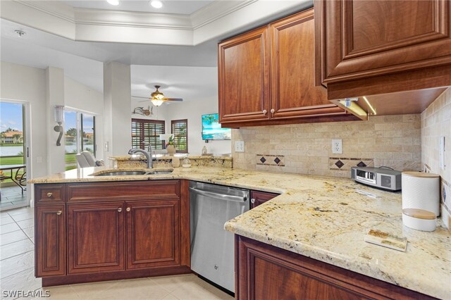 kitchen with ceiling fan, kitchen peninsula, sink, and stainless steel dishwasher