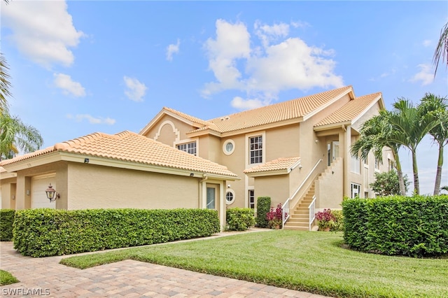 mediterranean / spanish-style house with a front lawn