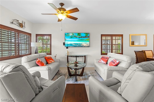 living room with a healthy amount of sunlight, wood-type flooring, and ceiling fan