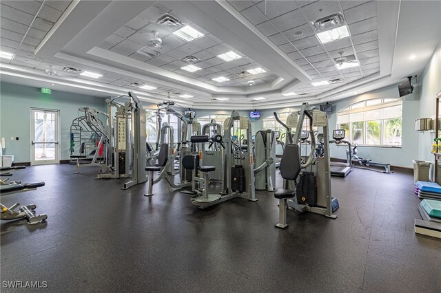 workout area with a tray ceiling and a paneled ceiling