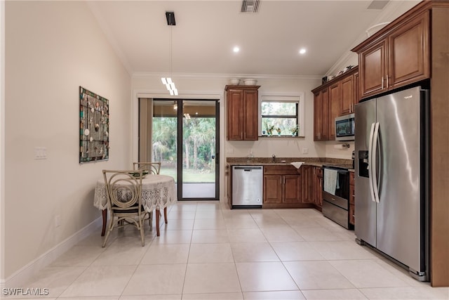 kitchen with ornamental molding, hanging light fixtures, light tile patterned floors, and stainless steel appliances