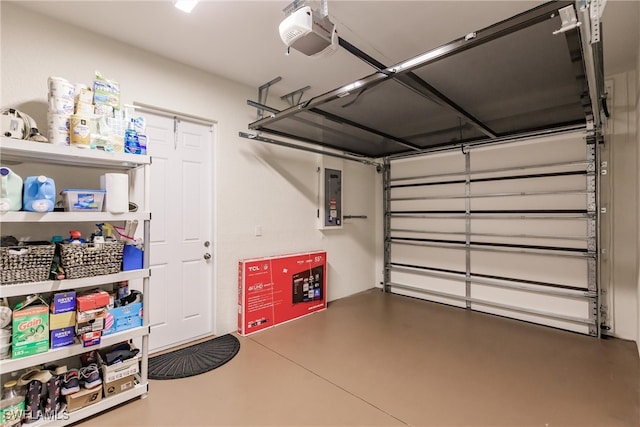 garage with a garage door opener and electric panel