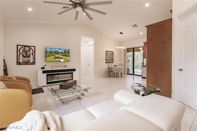 tiled living room with ceiling fan, crown molding, and vaulted ceiling