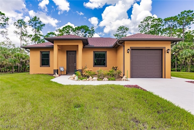 view of front facade with a garage and a front lawn