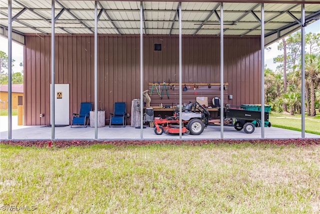 exterior space with a carport and a yard