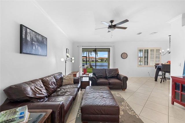 living room with ceiling fan with notable chandelier, ornamental molding, and a wealth of natural light