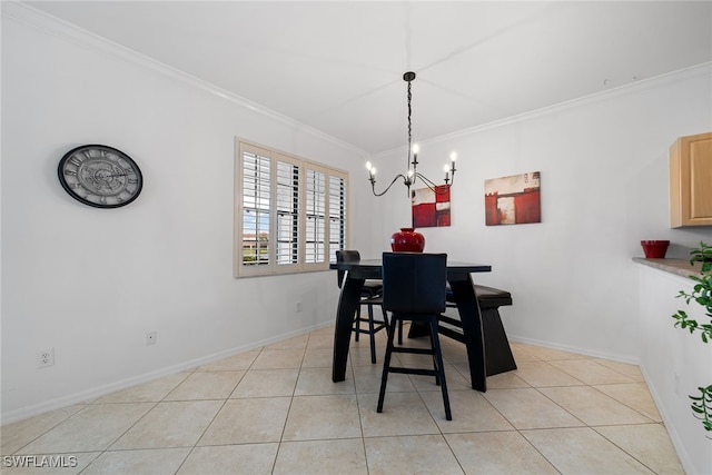 dining room with light tile patterned flooring, ornamental molding, and a chandelier