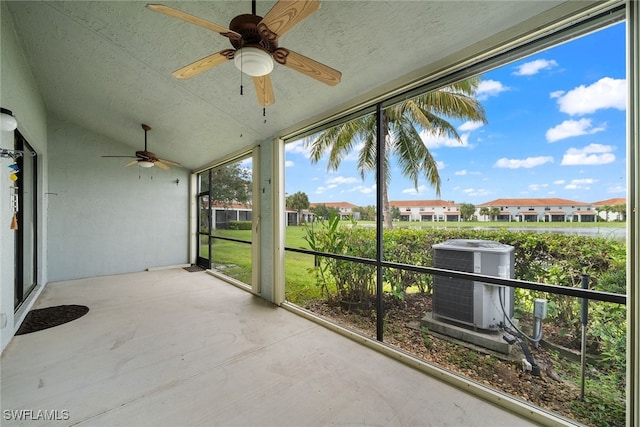 unfurnished sunroom with ceiling fan and vaulted ceiling