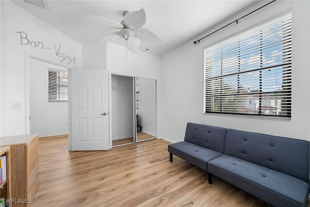 living area with light hardwood / wood-style flooring and ceiling fan