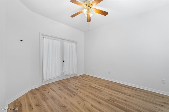 empty room featuring light wood-type flooring and ceiling fan