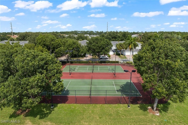 view of sport court with a yard