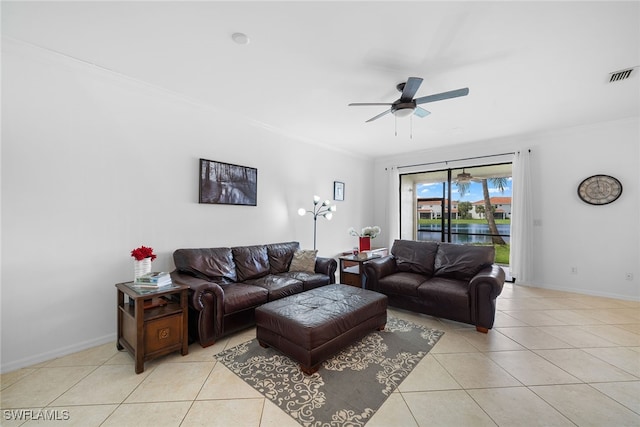 living room with light tile patterned floors, ornamental molding, and ceiling fan