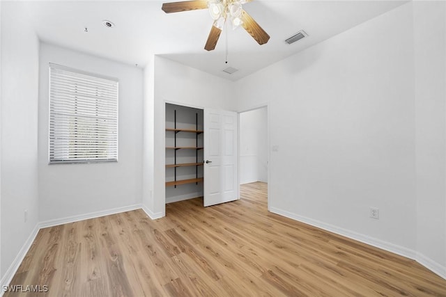 unfurnished bedroom with visible vents, light wood-style flooring, and baseboards