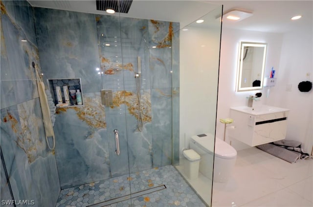 bathroom featuring vanity, toilet, and a shower with shower door