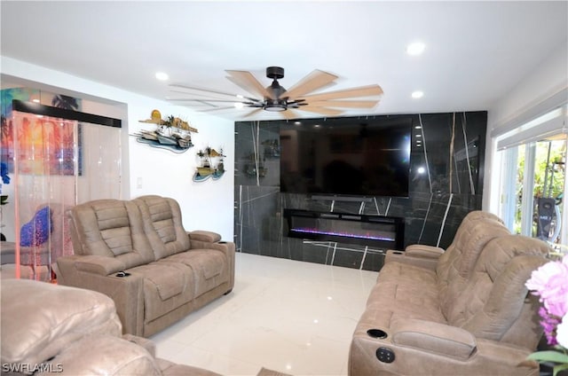 living room featuring ceiling fan and a fireplace