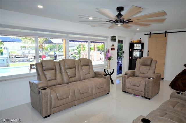 living room featuring a barn door and ceiling fan