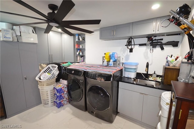 clothes washing area featuring ceiling fan, sink, and washer and clothes dryer