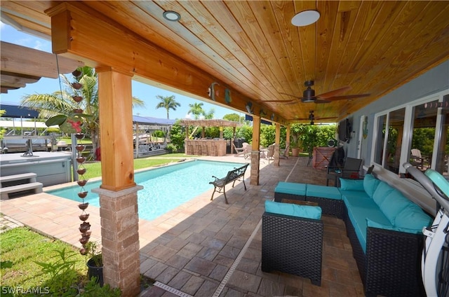 view of swimming pool featuring ceiling fan, a hot tub, an outdoor hangout area, and a patio area