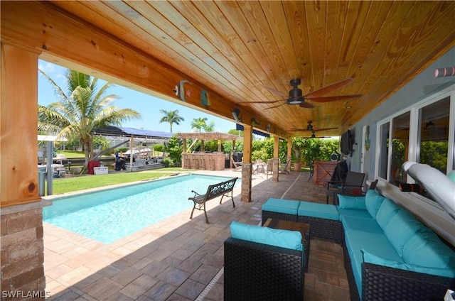 view of pool with a patio, outdoor lounge area, and ceiling fan