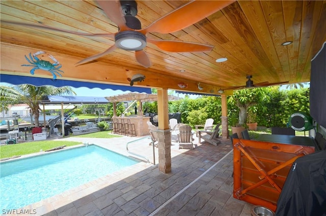 view of pool with a patio and an outdoor bar