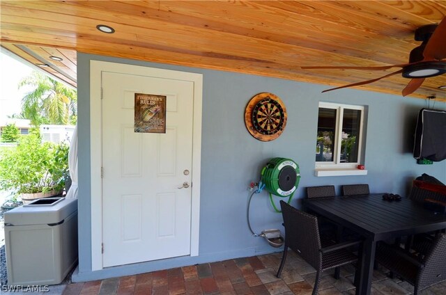 doorway to property featuring ceiling fan and a patio