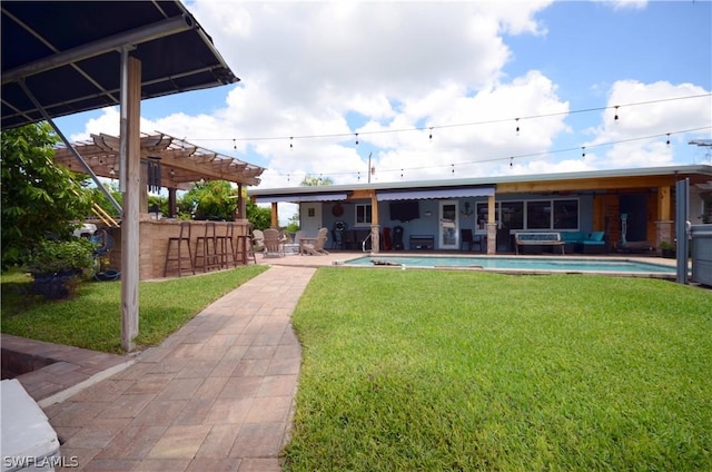 back of house featuring a pergola, a patio area, and a bar