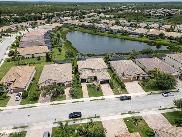 drone / aerial view with a residential view and a water view