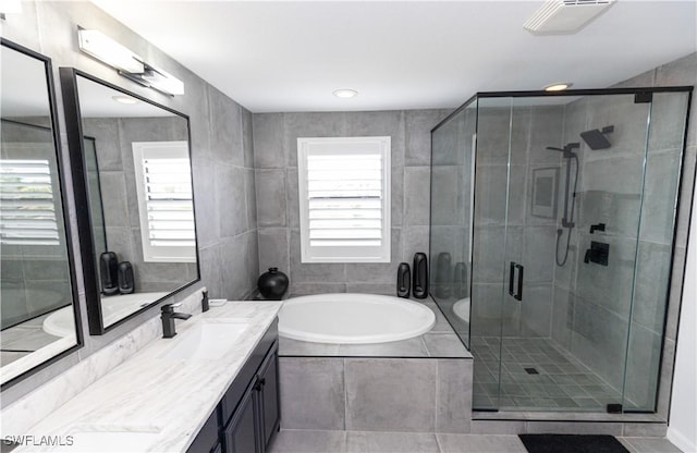 bathroom featuring vanity and separate shower and tub