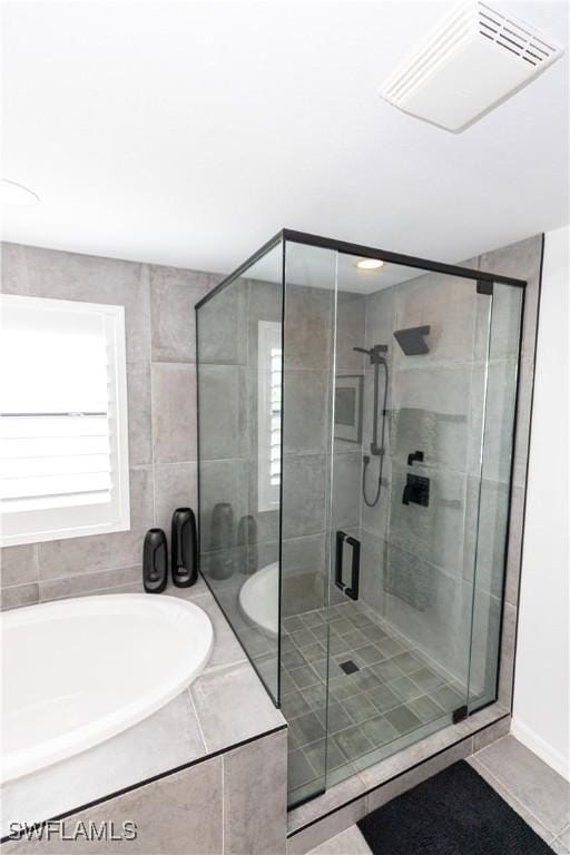 full bath with a stall shower, tile patterned flooring, visible vents, and a bath